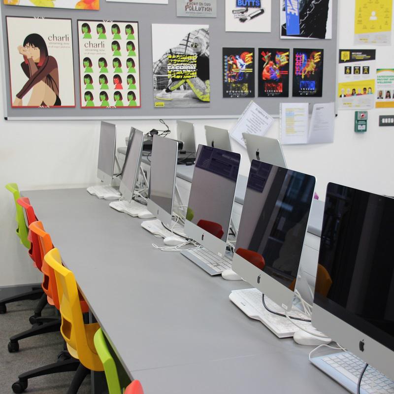Row of Macs and colourful chairs