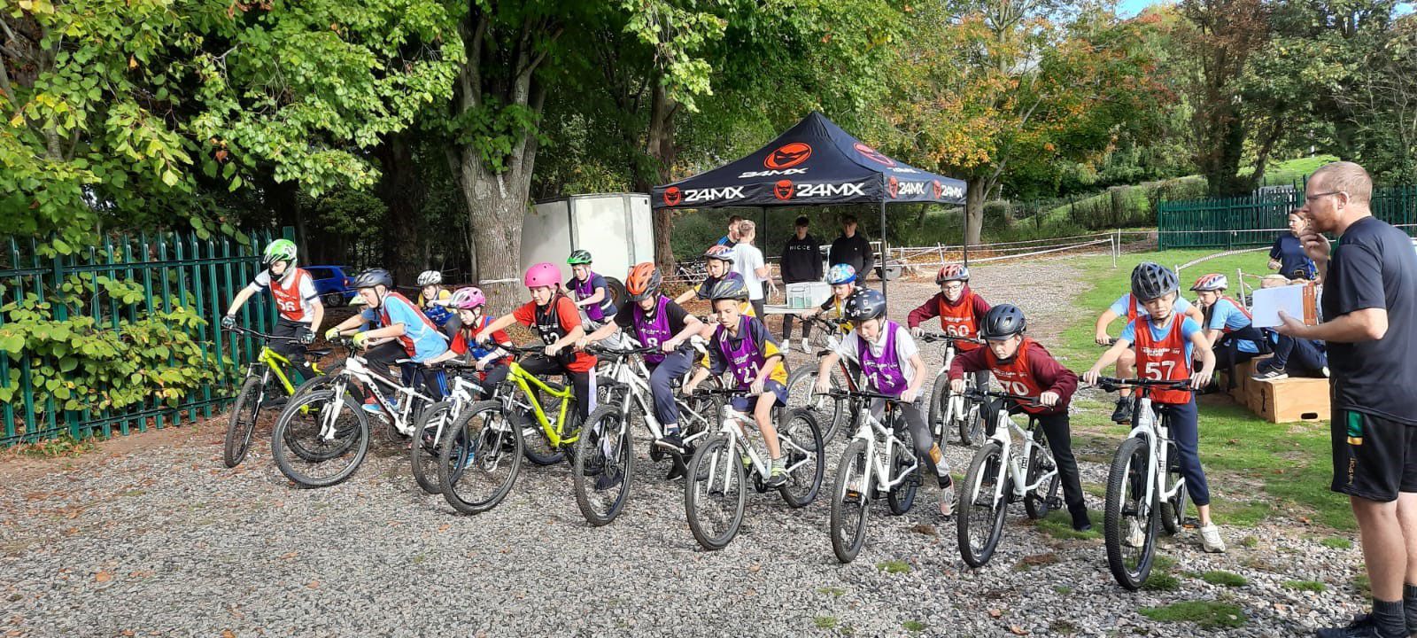 Primary school children on bikes lined up at a start line