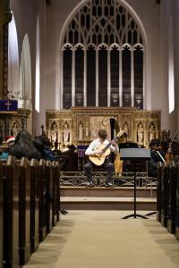 guitarists in a church