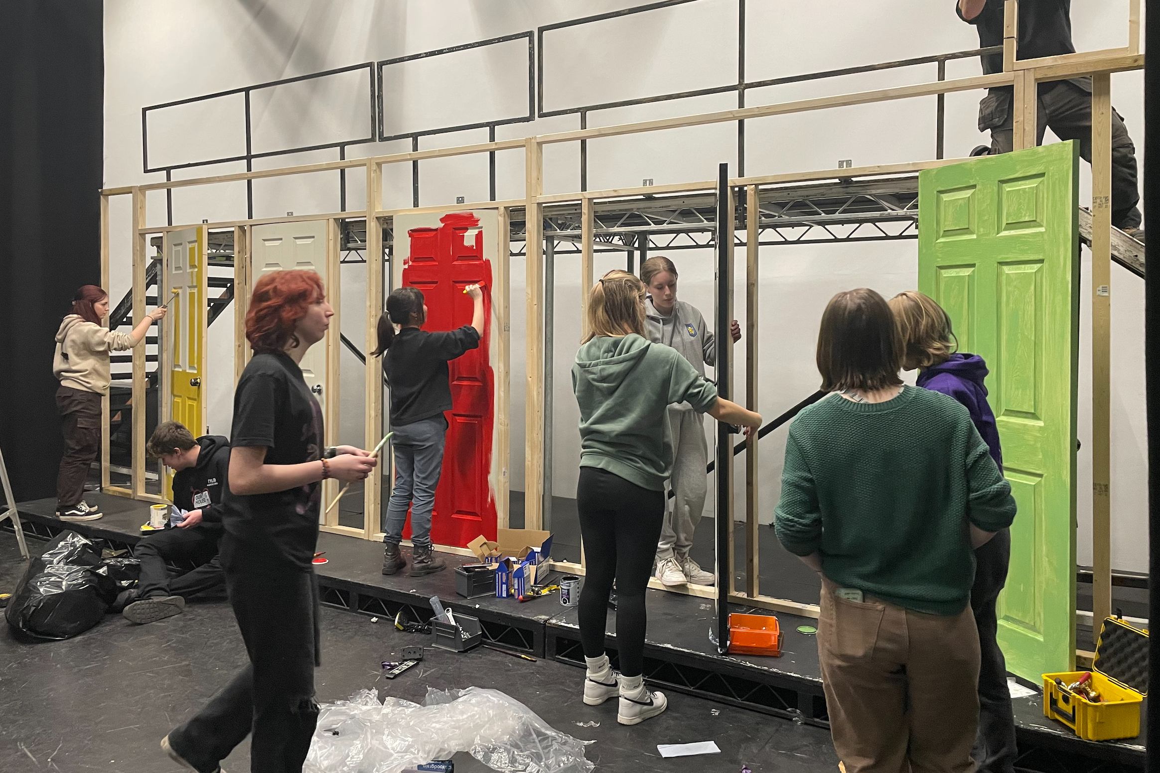 stage crew painting doors on set