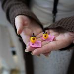 Two Mini plastic ducks in palm of hand