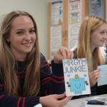 Student holding up a homemade card