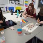 Students making badges and a rainbow flag