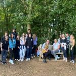 Many students stood by or sat on a bench