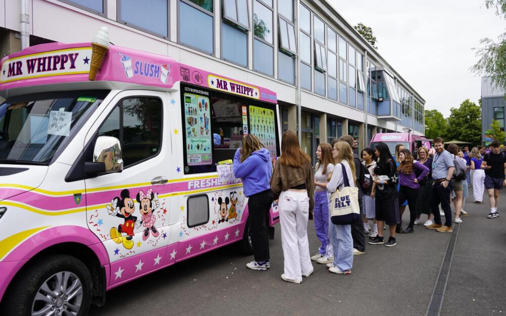 Students being served at an ice cream van.