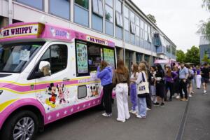 Students being served at an ice cream van.