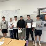 6 students standing up who participated in The Richard Huish College Dragons Den 2024