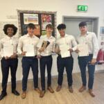5 students standing up who participated in The Richard Huish College Dragons Den 2024