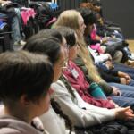 Students in the Huish theatre listening to a talk by Musgrove Park doctors at an Academic Enrich event.