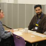 A doctor runs a practice interview with a Huish student hoping to study medicine at university.