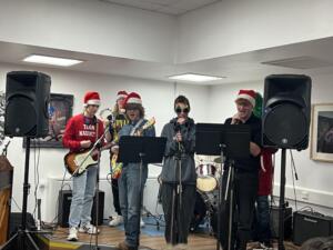 Band perfoming in Christmas jumpers