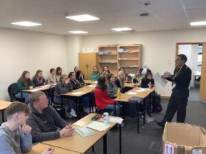 students fingerprinting workshop with a police officer