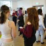 Students chatting at a key to careers event, run by Unloc.