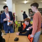 Students and the organiser chatting at a key to careers event, run by Unloc.