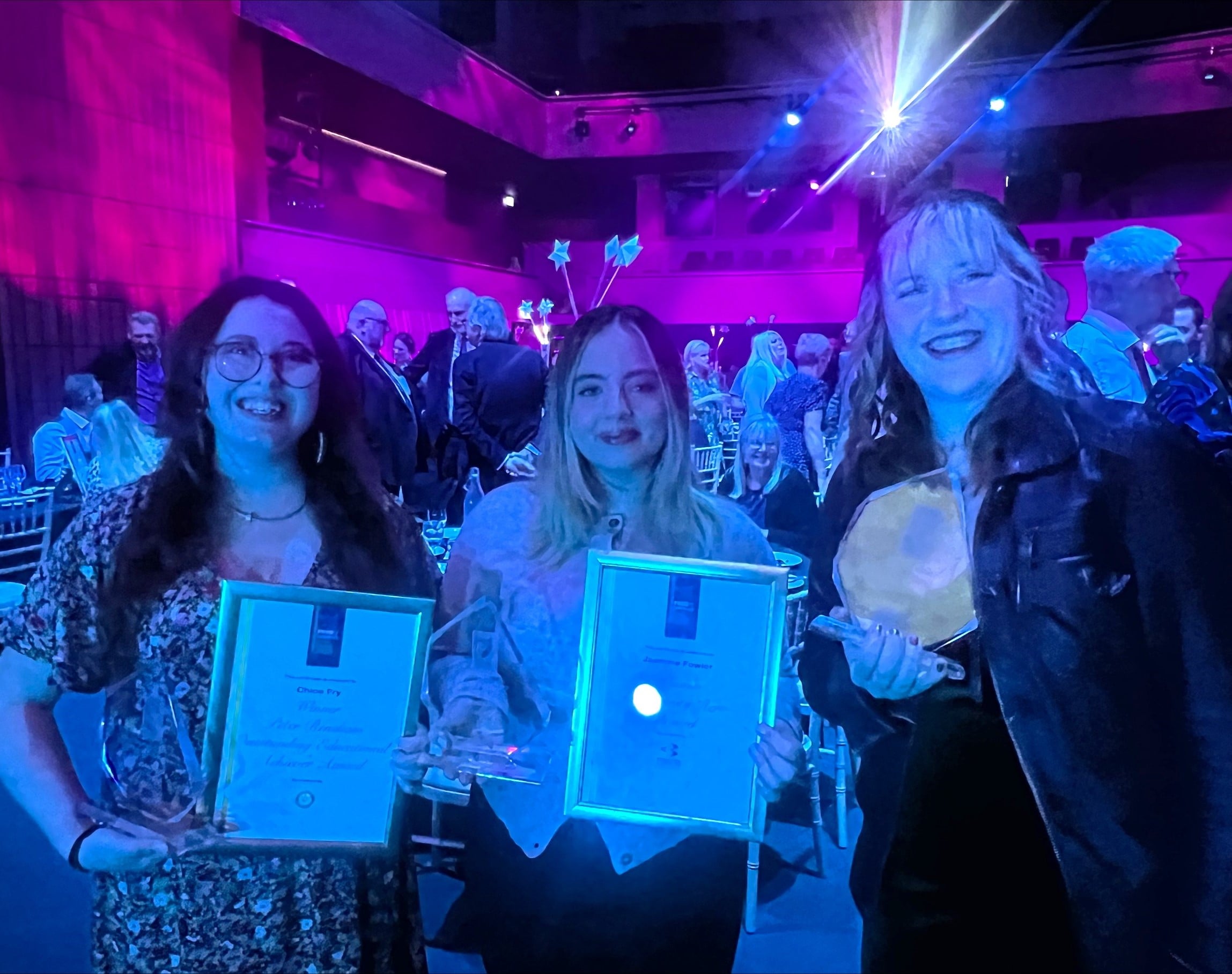 Three winners at the awards ceremony holding their trophies. From left to right Chloe Fry, Jasmine Fowler and Millicent Morgan-Holloway. Chloe and Jasmine also hold their certificates.