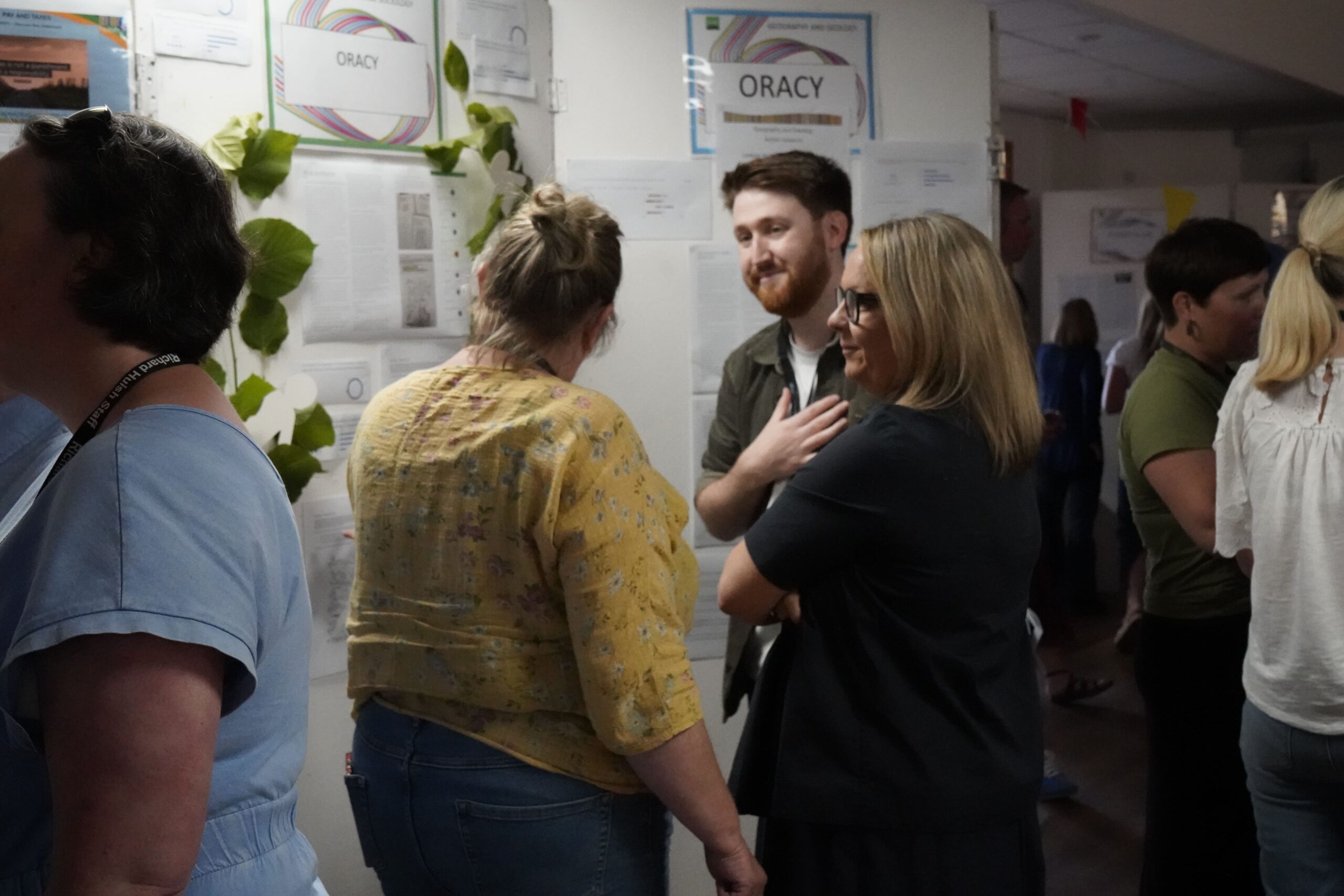 Staff in front of a stall at the action research marketplace.