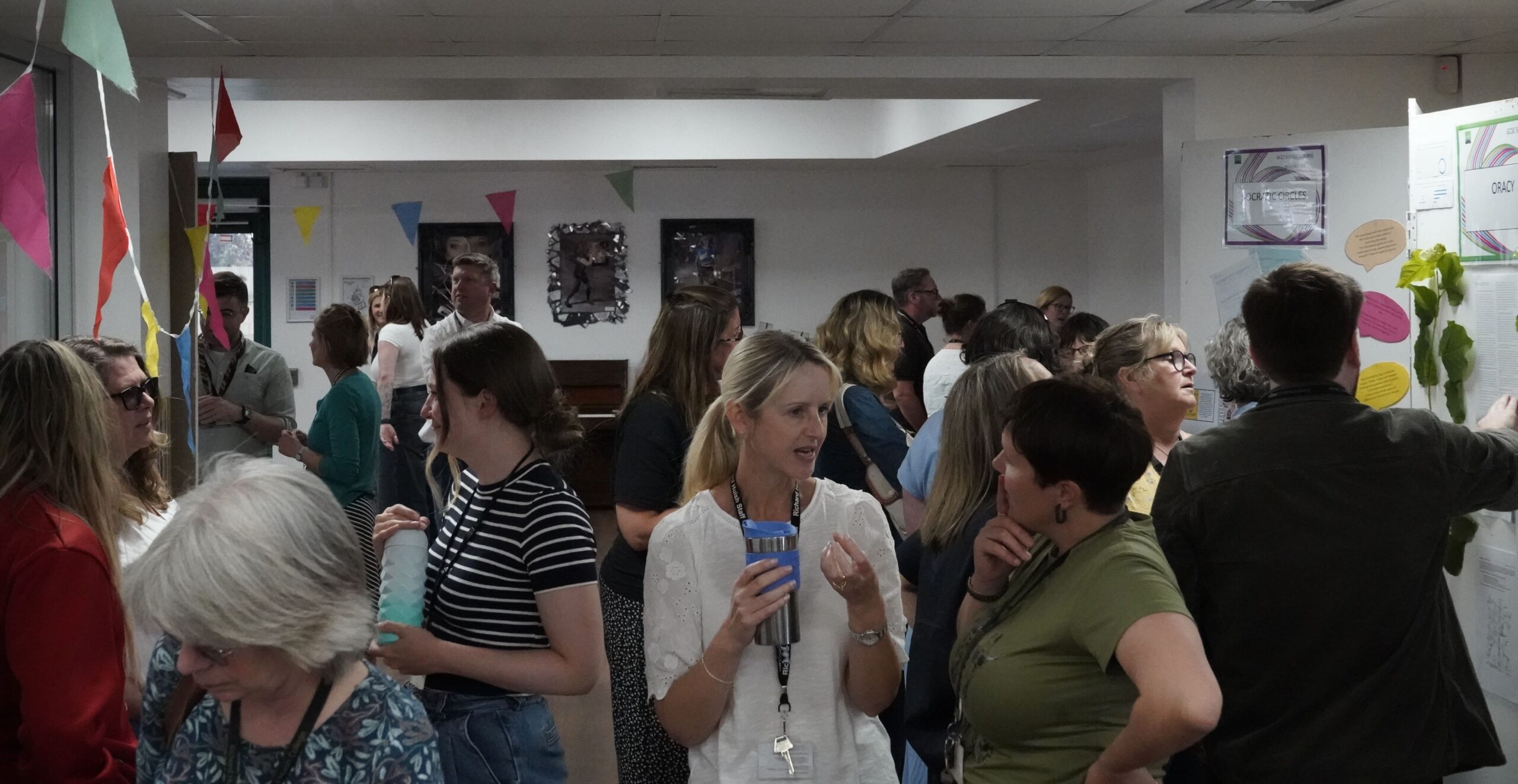 A busy room with lots of stands and staff chatting at the action research marketplace