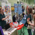 A lady talking to students at an Education Apprenticeships stall