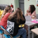 2 students sat down chatting to a careers adviser