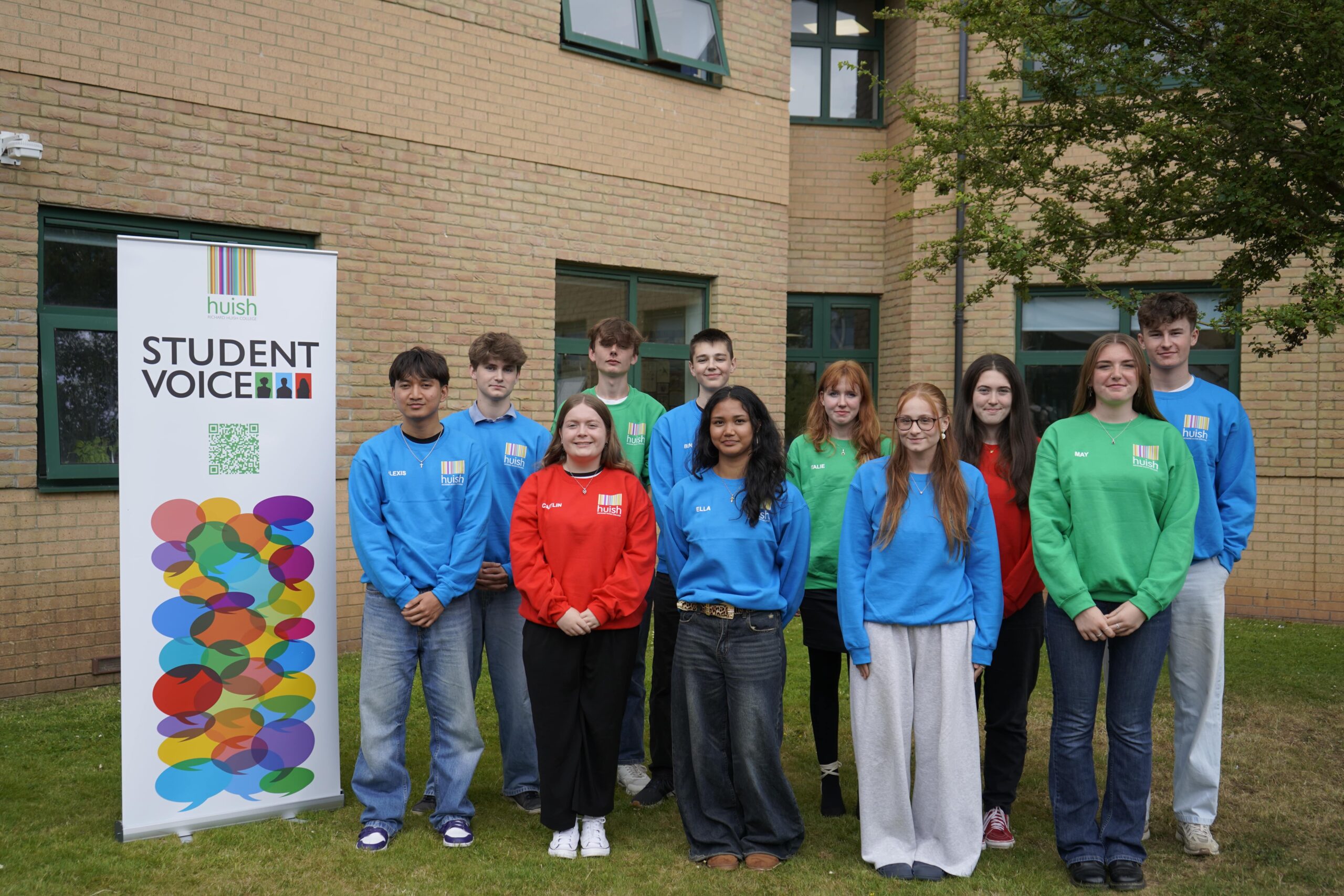 Student Executive Student Executive stood by a banner reading studnet voice, all wearing colourful jumpers