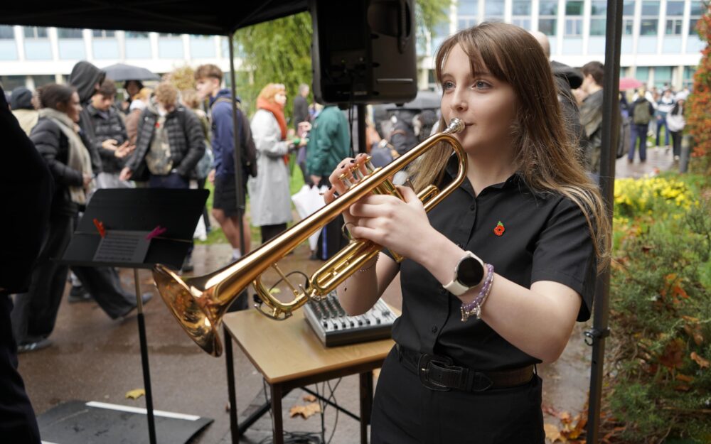 A student holds a trumpet.