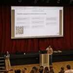 man in front of projector screen