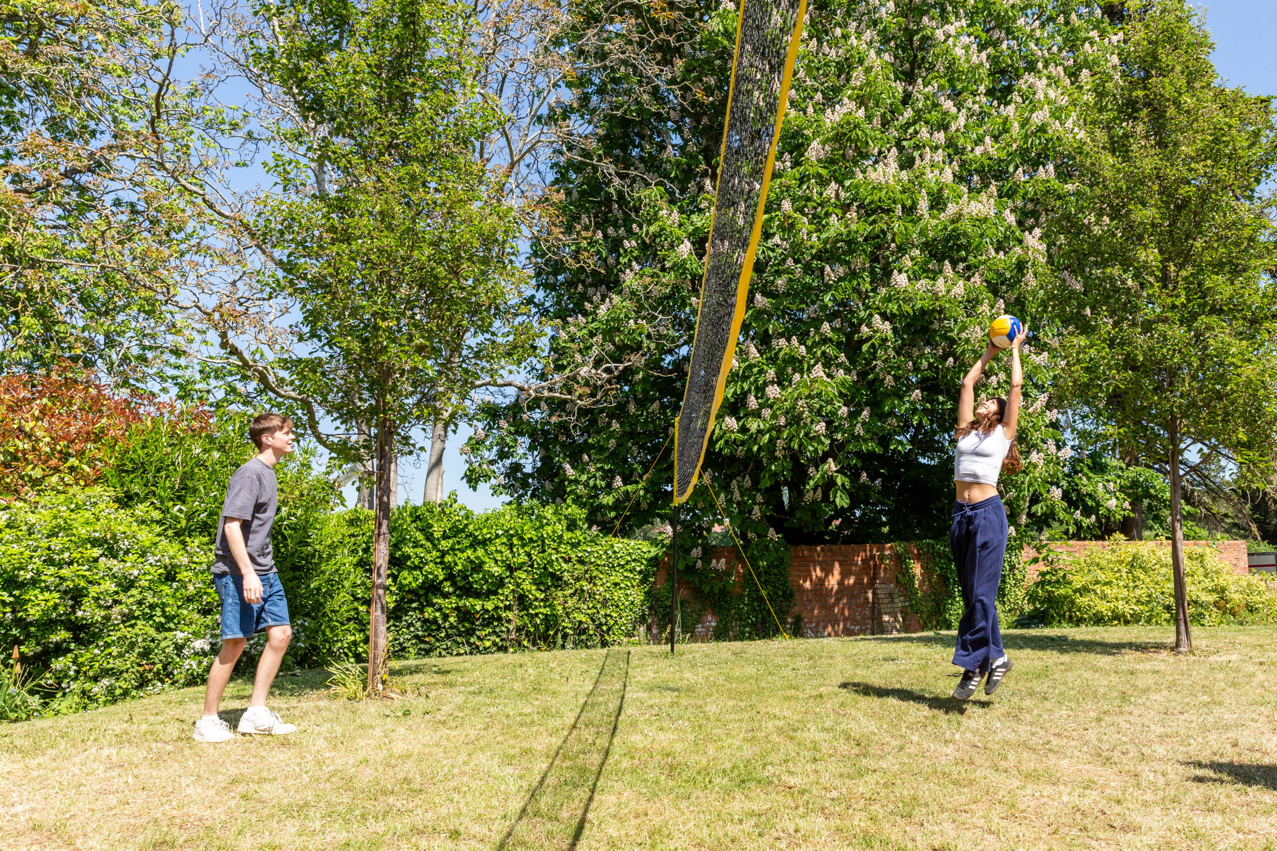 Students playing volleyball outside