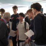A group of students chatting to a professional at a networking event.