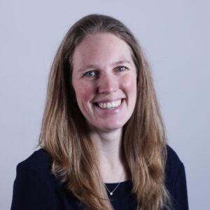 A lady with long hair smiling at the camera.
