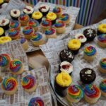 Colourful iced cupcakes. Some are chocolate.