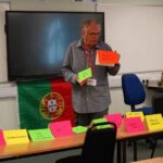 A business or university representative giving a talk in a classroom.