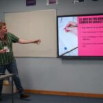 A business or university representative giving a talk in a classroom.