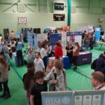 A busy careers fair, with lots of different exhibition stands.