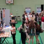 A busy careers fair, with lots of different exhibition stands.